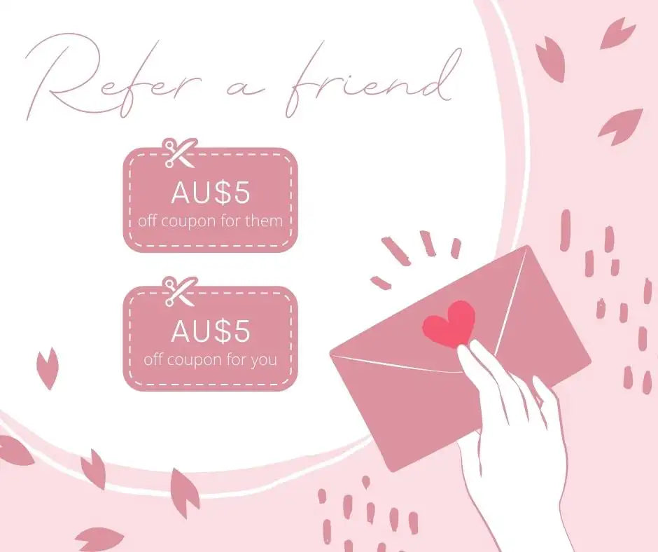 Pink envelope with a red heart sticker being held by a hand.